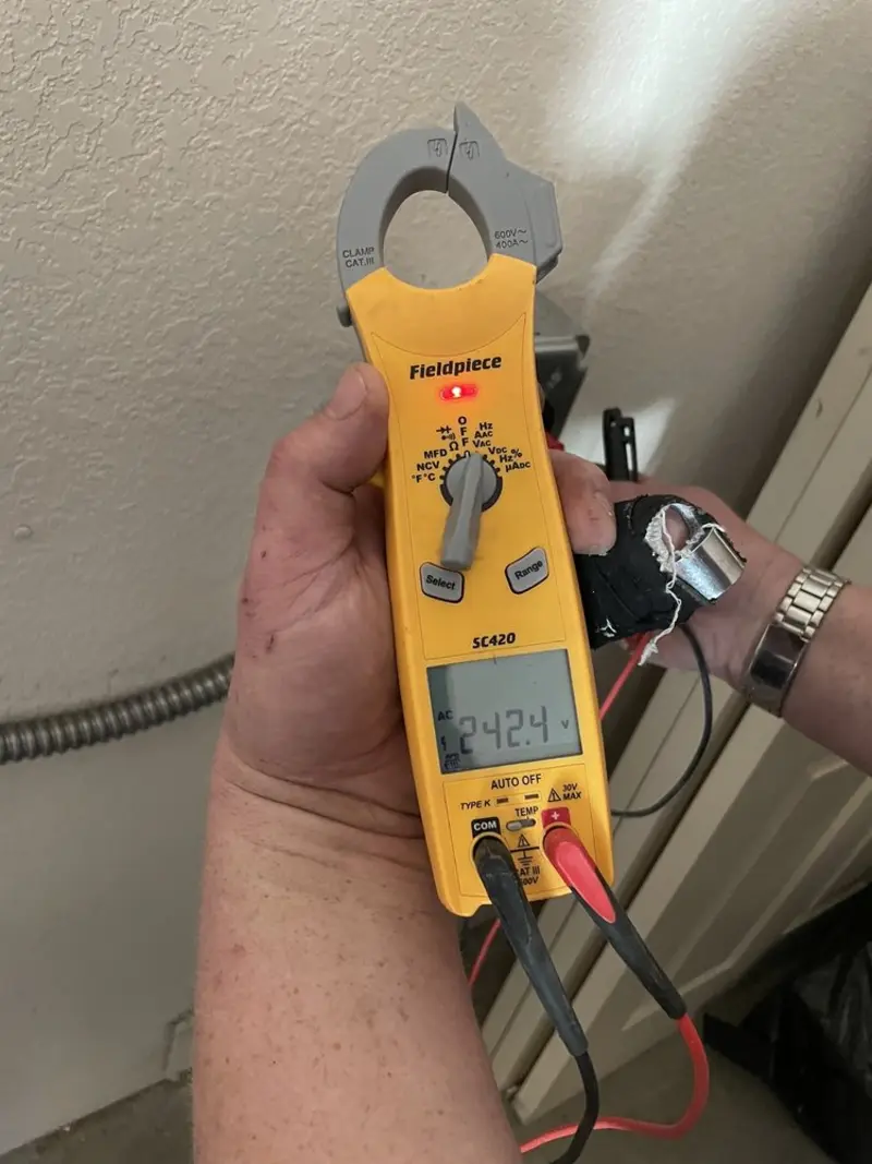 Voltage testing with clamp meter during Recessed Lighting Installation in Theodore